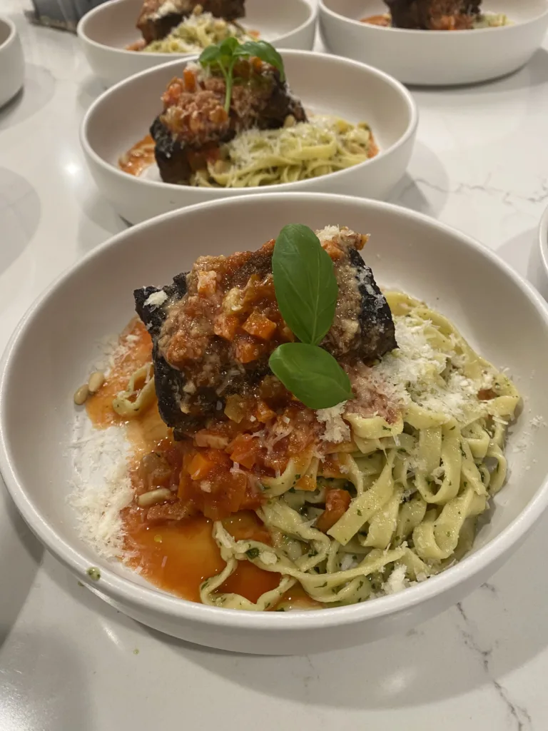 Bowls of pasta with meatballs in tomato sauce