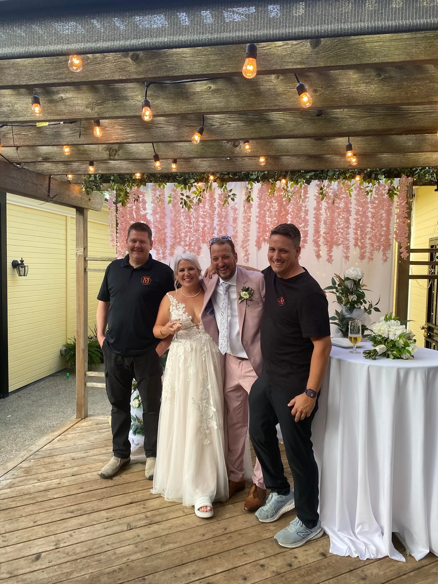A newly married couple with two Monarch Culinary chefs at their wedding reception