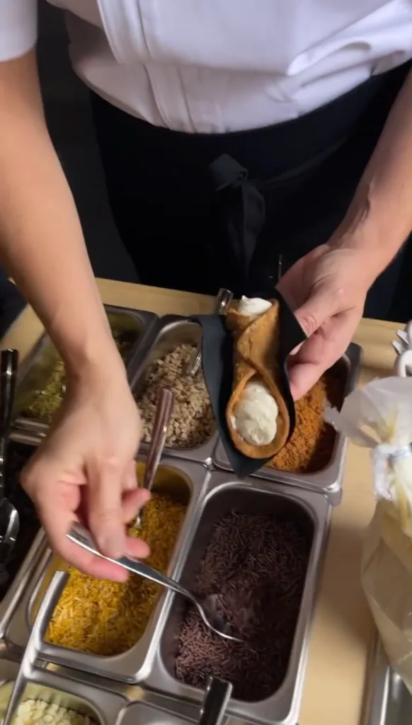Monarch Culinary chef filling cannoli at a dessert station