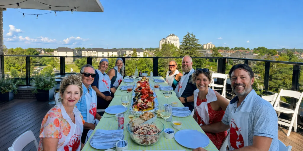 Guests around a rooftop table at a Monarch Culinary lobster boil