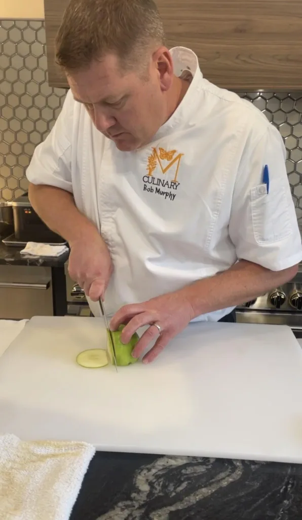 Chef Bob Murphy slicing cucumber at the Monarch Culinary Studio