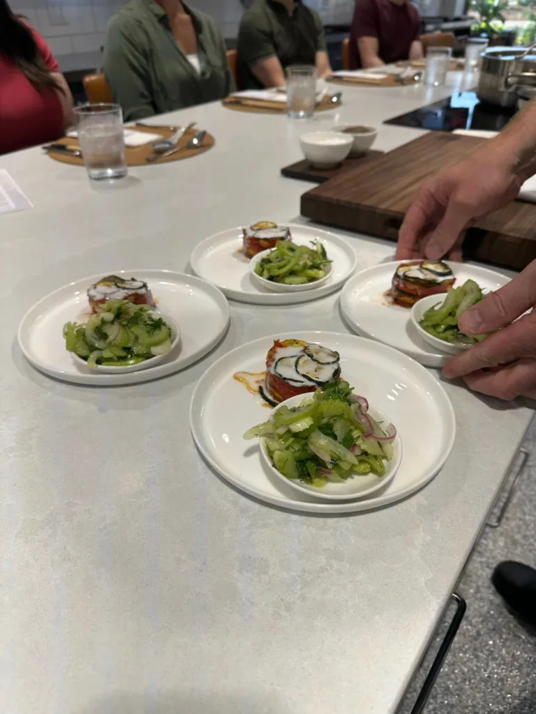 Vegetable tian and cucumber salad plated at the Monarch Culinary Studio