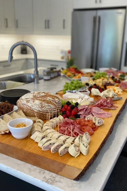 Charcuterie and grazing board laid out on a kitchen island