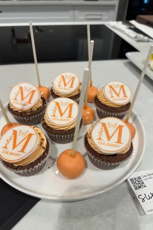 Monarch-branded cupcakes and cake pops with the M Culinary logo