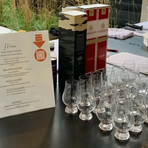 Event drinks station with a printed menu card and rows of glassware